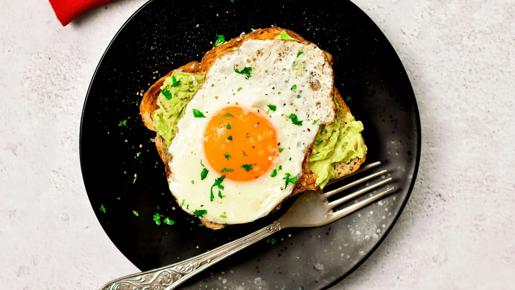 Sunny side up egg served on avocado toast at Fluff and Crunch breakfast restaurant in Warman, SK
